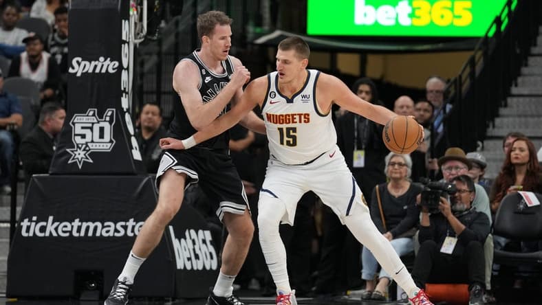 Nov 7, 2022; San Antonio, Texas, USA; Denver Nuggets center Nikola Jokic (15) backs in against San Antonio Spurs center Jakob Poeltl (25) in the first half at the AT&T Center. Mandatory Credit: Daniel Dunn-USA TODAY Sports