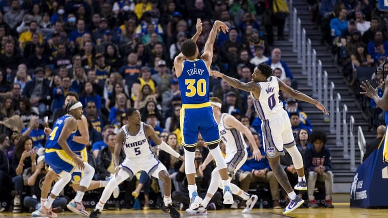 Nov 7, 2022; San Francisco, California, USA; Golden State Warriors guard Stephen Curry (30) takes a three-point shot over Sacramento Kings guard Malik Monk (0) during the first half at Chase Center. Mandatory Credit: John Hefti-USA TODAY Sports