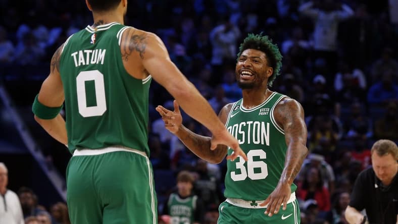 Boston Celtics guard Marcus Smart (36) reacts with forward Jayson Tatum (0) after a dunk during the second half against the Memphis Grizzlies at FedExForum. Mandatory Credit: Petre Thomas-USA TODAY Sports