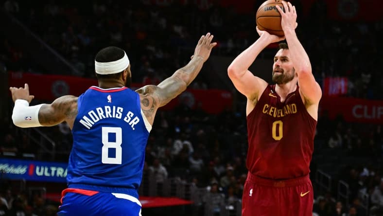 Nov 7, 2022; Los Angeles, California, USA; Cleveland Cavaliers forward Kevin Love (0) attempts a shot as Los Angeles Clippers forward Marcus Morris Sr. (8) defends in the fourth quarter at Crypto.com Arena. Mandatory Credit: Richard Mackson-USA TODAY Sports