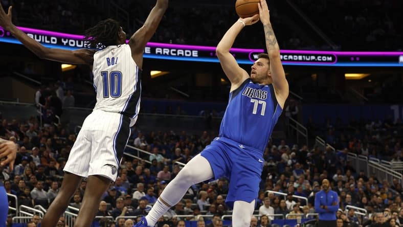 Nov 9, 2022; Orlando, Florida, USA; Dallas Mavericks guard Luka Doncic (77) shoots over Orlando Magic center Bol Bol (10) during the first quarter at Amway Center. Mandatory Credit: Kim Klement-USA TODAY Sports