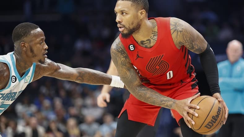 Nov 9, 2022; Charlotte, North Carolina, USA; Portland Trail Blazers guard Damian Lillard (0) looks to drive against Charlotte Hornets guard Terry Rozier (3) during the second quarter at Spectrum Center. Mandatory Credit: Nell Redmond-USA TODAY Sports
