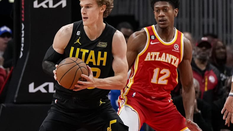Nov 9, 2022; Atlanta, Georgia, USA; Utah Jazz forward Lauri Markkanen (23) handles the ball in front off Atlanta Hawks forward De'Andre Hunter (12) during the first half at State Farm Arena. Mandatory Credit: Dale Zanine-USA TODAY Sports