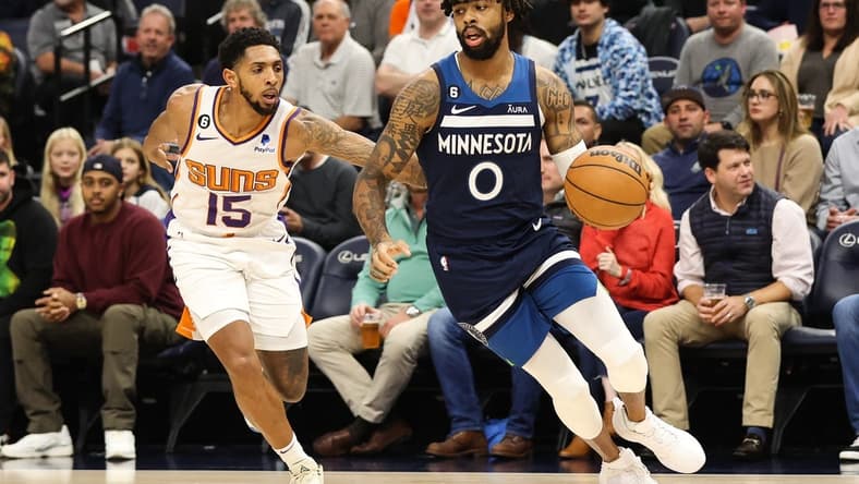 Nov 9, 2022; Minneapolis, Minnesota, USA; Minnesota Timberwolves guard D'Angelo Russell (0) dribbles the ball while Phoenix Suns guard Cameron Payne (15) defends during the first quarter at Target Center. Mandatory Credit: Matt Krohn-USA TODAY Sports