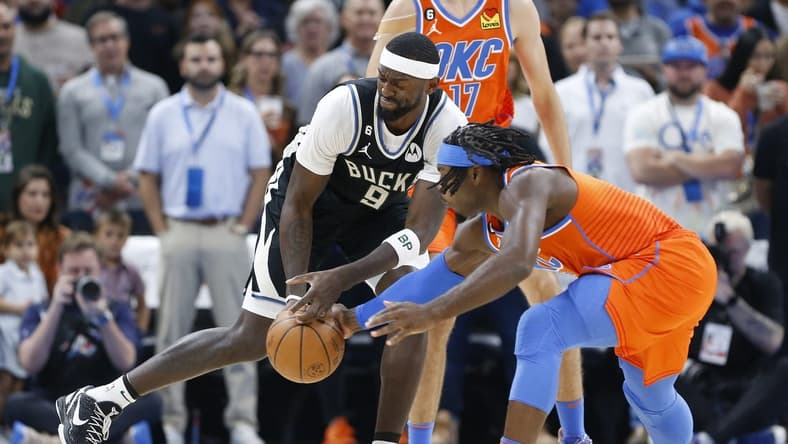 Nov 9, 2022; Oklahoma City, Oklahoma, USA; Oklahoma City Thunder forward Luguentz Dort (5) and Milwaukee Bucks forward Bobby Portis (9) reach for a loose ball during the first quarter at Paycom Center. Mandatory Credit: Alonzo Adams-USA TODAY Sports