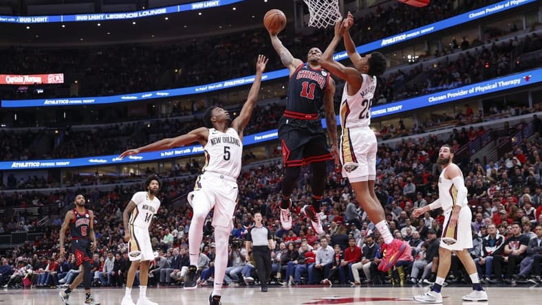 Nov 9, 2022; Chicago, Illinois, USA; Chicago Bulls forward DeMar DeRozan (11) goes up for a dunk against the New Orleans Pelicans during the first half at United Center. Mandatory Credit: Kamil Krzaczynski-USA TODAY Sports