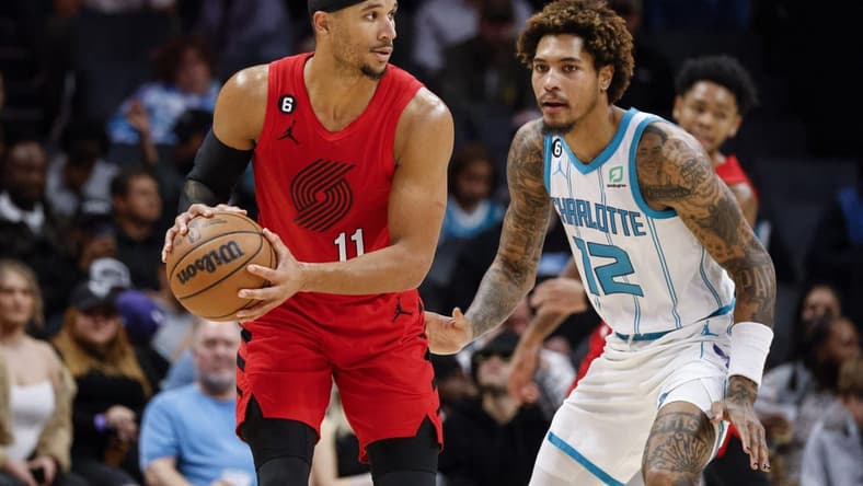 Nov 9, 2022; Charlotte, North Carolina, USA; Portland Trail Blazers guard Josh Hart (11) looks to pass against Charlotte Hornets guard Kelly Oubre Jr. (12) in the second half at Spectrum Center. The Portland Trail Blazers won 105-95. Mandatory Credit: Nell Redmond-USA TODAY Sports