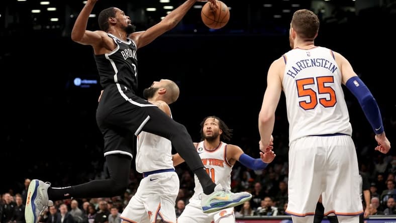 Nov 9, 2022; Brooklyn, New York, USA; Brooklyn Nets forward Kevin Durant (7) fights for the ball against New York Knicks guard Evan Fournier (13) and guard Jalen Brunson (11) and center Isaiah Hartenstein (55) during the third quarter at Barclays Center. Mandatory Credit: Brad Penner-USA TODAY Sports