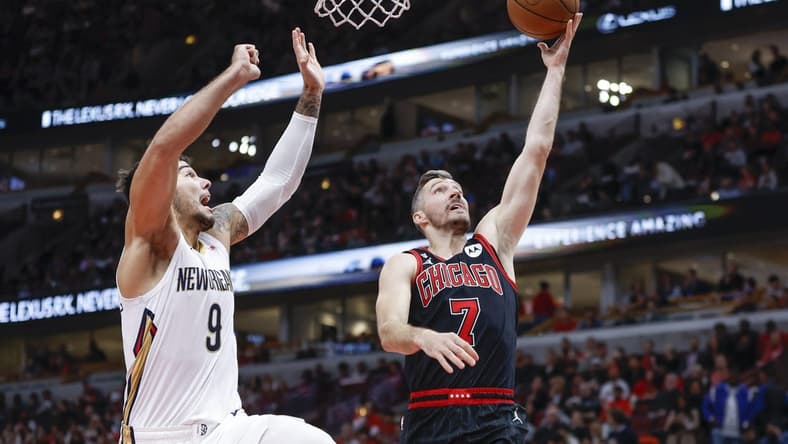 Nov 9, 2022; Chicago, Illinois, USA; Chicago Bulls guard Goran Dragic (7) goes to the basket against New Orleans Pelicans center Willy Hernangomez (9) during the first half at United Center. Mandatory Credit: Kamil Krzaczynski-USA TODAY Sports