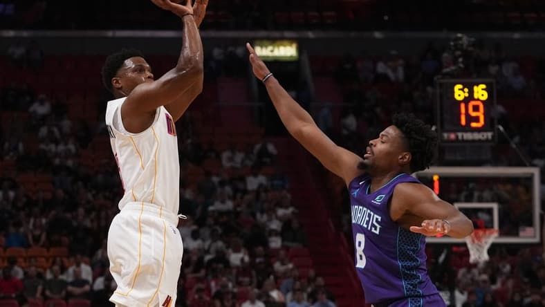 Nov 10, 2022; Miami, Florida, USA; Miami Heat guard Kyle Lowry (7) attempts to shoot the ball over Charlotte Hornets guard Dennis Smith Jr. (8) during the first half at FTX Arena. Mandatory Credit: Jasen Vinlove-USA TODAY Sports