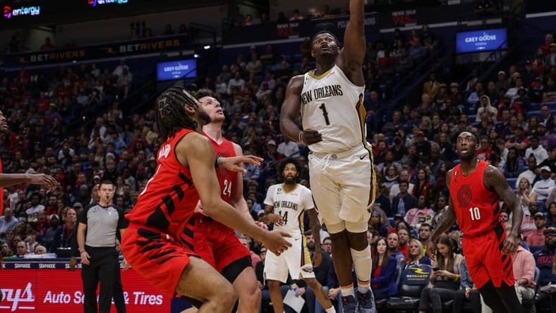 Nov 10, 2022; New Orleans, Louisiana, USA; New Orleans Pelicans forward Zion Williamson (1) drives to the basket against Portland Trail Blazers forward Drew Eubanks (24) and forward Trendon Watford (2) during the second half at Smoothie King Center. Mandatory Credit: Stephen Lew-USA TODAY Sports