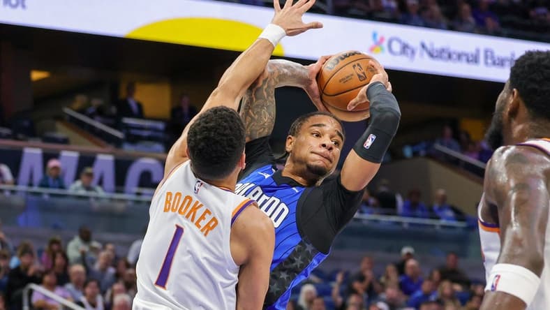 Nov 11, 2022; Orlando, Florida, USA; Orlando Magic forward Chuma Okeke (3) looks to pass around Phoenix Suns guard Devin Booker (1) during the first quarter at Amway Center. Mandatory Credit: Mike Watters-USA TODAY Sports