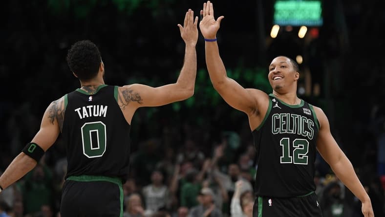 Nov 11, 2022; Boston, Massachusetts, USA; Boston Celtics forward Jayson Tatum (0) high fives forward Grant Williams (12) during the second half against the Denver Nuggets at TD Garden. Mandatory Credit: Bob DeChiara-USA TODAY Sports