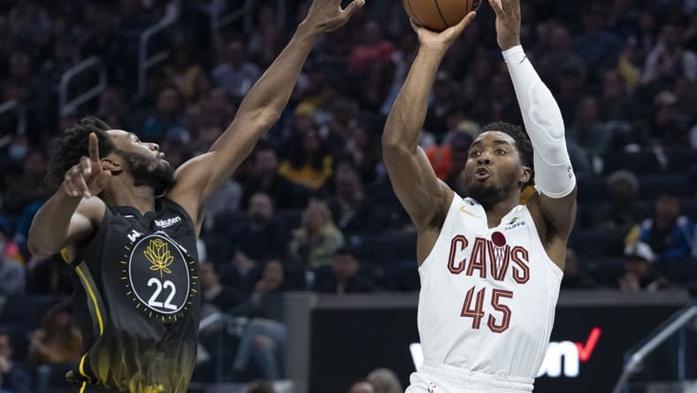 November 11, 2022; San Francisco, California, USA; Cleveland Cavaliers guard Donovan Mitchell (45) shoots the basketball against Golden State Warriors forward Andrew Wiggins (22) during the second quarter at Chase Center. Mandatory Credit: Kyle Terada-USA TODAY Sports