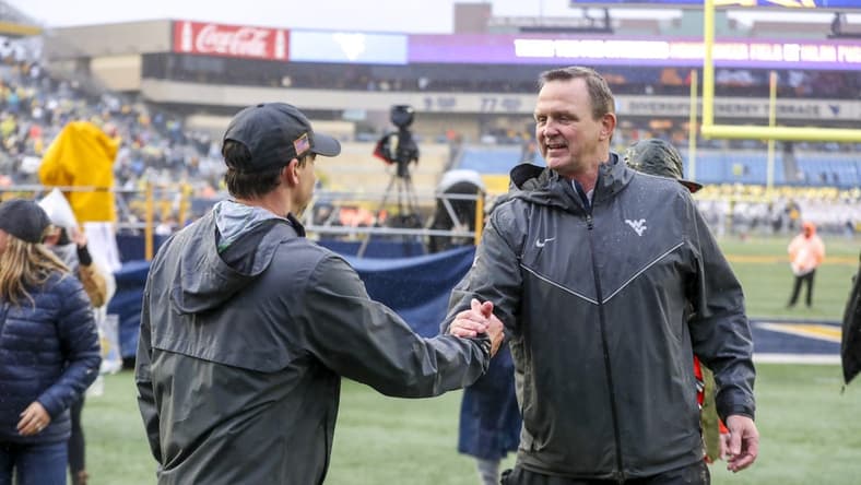 Nov 12, 2022; Morgantown, West Virginia, USA; West Virginia Mountaineers athletic director Shane Lyons celebrates with West Virginia Mountaineers head coach Neal Brown after defeating the Oklahoma Sooners at Mountaineer Field at Milan Puskar Stadium. Mandatory Credit: Ben Queen-USA TODAY Sports