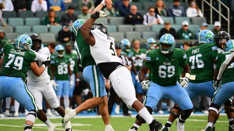 Nov 12, 2022; New Orleans, Louisiana, USA; UCF Knights defensive tackle Ricky Barber (5) sacks Tulane Green Wave quarterback Michael Pratt (7) during the first quarter at Yulman Stadium. Mandatory Credit: Rebecca Warren-USA TODAY Sports