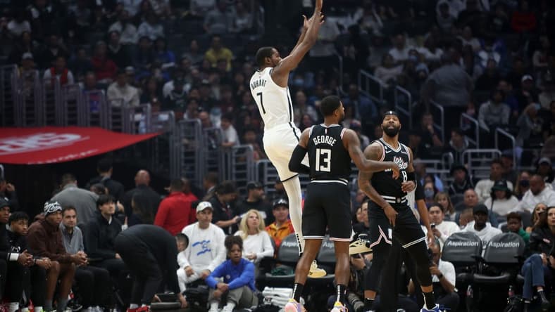 Nov 12, 2022; Los Angeles, California, USA;  Brooklyn Nets forward Kevin Durant (7) shoots a ball against LA Clippers guard Paul George (13) and forward Marcus Morris Sr. (8) during the first quarter at Crypto.com Arena. Mandatory Credit: Kiyoshi Mio-USA TODAY Sports