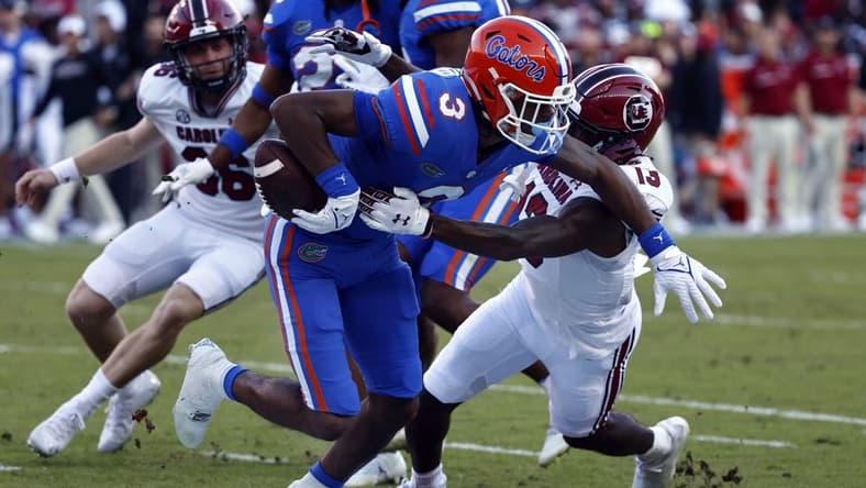 Nov 12, 2022; Gainesville, Florida, USA; South Carolina Gamecocks wide receiver Jalen Brooks (13) causes Florida Gators wide receiver Xzavier Henderson (3) to fumble the ball on special teams during the first quarter at Ben Hill Griffin Stadium. Mandatory Credit: Kim Klement-USA TODAY Sports