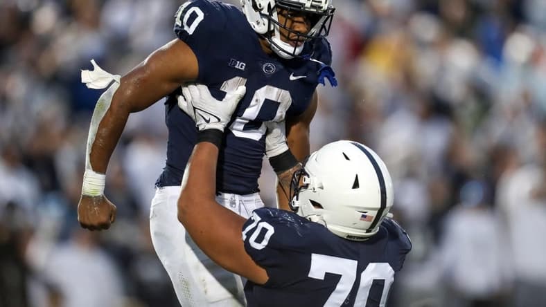 Nov 12, 2022; University Park, Pennsylvania, USA; Penn State Nittany Lions running back Nicholas Singleton (10) celebrates with offensive linesman Juice Scruggs (70) after scoring a touchdown during the second quarter against the Maryland Terrapins at Beaver Stadium. Penn State defeated Maryland 30-0. Mandatory Credit: Matthew OHaren-USA TODAY Sports