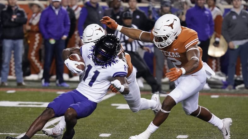 Nov 12, 2022; Austin, Texas, USA; Texas Longhorns linebacker Diamonte Tucker-Dorsey (2) tackles Texas Christian Horned Frogs kick returner Derius Davis (11) during the opening kickoff at Darrell K Royal-Texas Memorial Stadium. Mandatory Credit: Scott Wachter-USA TODAY Sports