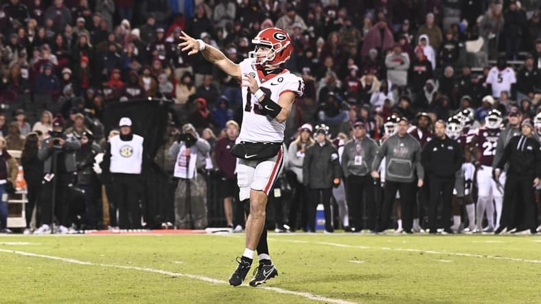 Nov 12, 2022; Starkville, Mississippi, USA; Georgia Bulldogs quarterback Stetson Bennett (13) throws a pass against the Mississippi State Bulldogs that would result in a touchdown during the first quarter at Davis Wade Stadium at Scott Field. Mandatory Credit: Matt Bush-USA TODAY Sports