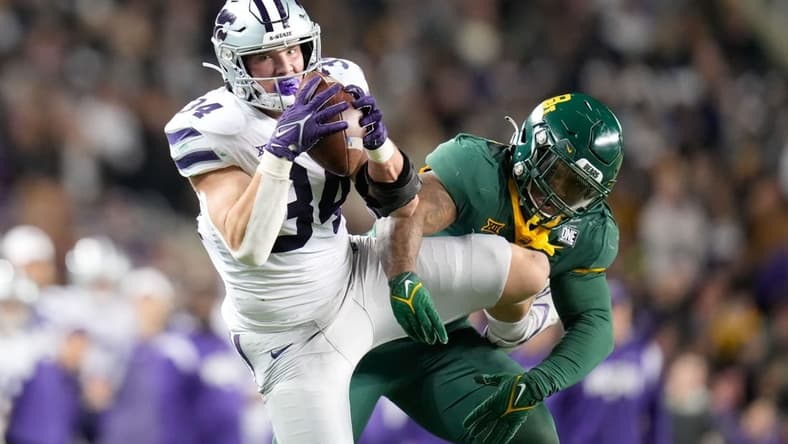 Nov 12, 2022; Waco, Texas, USA; Kansas State Wildcats tight end Ben Sinnott (34) catches the ball as Baylor Bears linebacker Jackie Marshall (35) defends during the first half at McLane Stadium. Mandatory Credit: Chris Jones-USA TODAY Sports