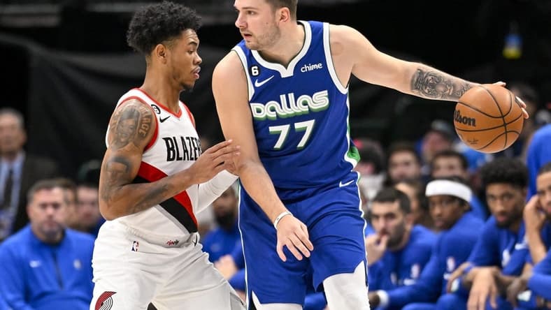 Nov 12, 2022; Dallas, Texas, USA; Portland Trail Blazers guard Anfernee Simons (1) guards Dallas Mavericks guard Luka Doncic (77) during the first quarter at the American Airlines Center. Mandatory Credit: Jerome Miron-USA TODAY Sports