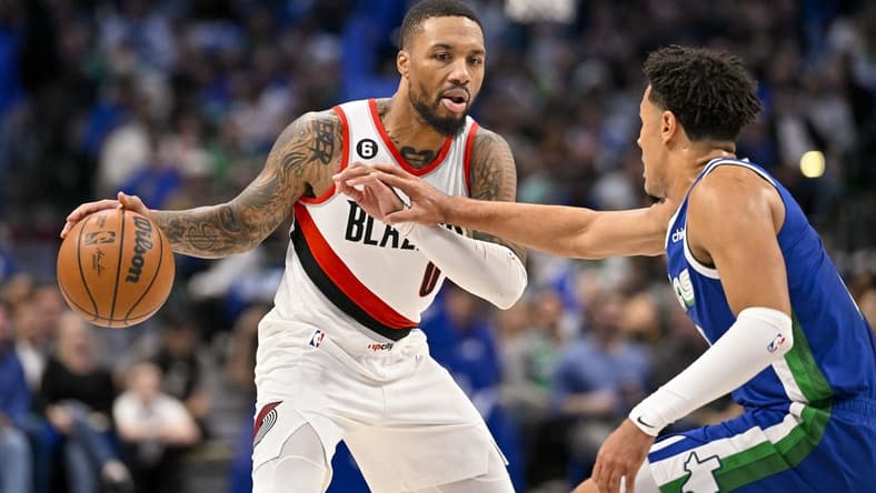 Nov 12, 2022; Dallas, Texas, USA; Dallas Mavericks guard Josh Green (8) guards Portland Trail Blazers guard Damian Lillard (0) during the second quarter at the American Airlines Center. Mandatory Credit: Jerome Miron-USA TODAY Sports