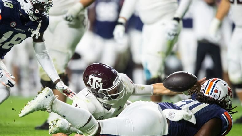 Texas A&M Aggies quarterback Conner Weigman (15) and Auburn Tigers defensive lineman Marcus Harris (50) dive for a fumble recovered by Weigman as Auburn Tigers take on Texas A&M Aggies at Jordan-Hare Stadium in Auburn, Ala., on Saturday, Nov. 12, 2022.