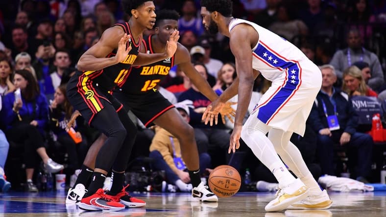 Nov 12, 2022; Philadelphia, Pennsylvania, USA; Atlanta Hawks forward De'Andre Hunter (12) defends Philadelphia 76ers center Joel Embiid (21) in the second quarter at Wells Fargo Center. Mandatory Credit: Kyle Ross-USA TODAY Sports
