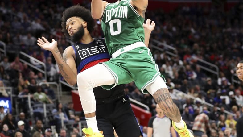 Nov 12, 2022; Detroit, Michigan, USA; Boston Celtics forward Jayson Tatum (0) scores against Detroit Pistons forward Marvin Bagley III (35) during the third period at Little Caesars Arena. Mandatory Credit: Kirthmon F. Dozier-USA TODAY Sports