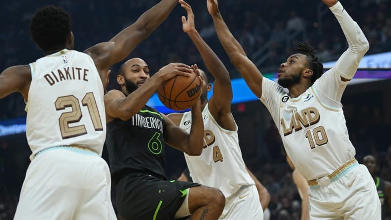 Nov 13, 2022; Cleveland, Ohio, USA; Minnesota Timberwolves guard Jordan McLaughlin (6) drives to the basket against Cleveland Cavaliers forward Mamadi Diakite (21) and forward Evan Mobley (4) and guard Darius Garland (10) during the first half at Rocket Mortgage FieldHouse. Mandatory Credit: Ken Blaze-USA TODAY Sports