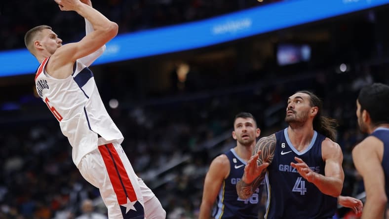 Nov 13, 2022; Washington, District of Columbia, USA; Washington Wizards center Kristaps Porzingis (6) shoots the ball over Memphis Grizzlies center Steven Adams (4) in the first quarter at Capital One Arena. Mandatory Credit: Geoff Burke-USA TODAY Sports