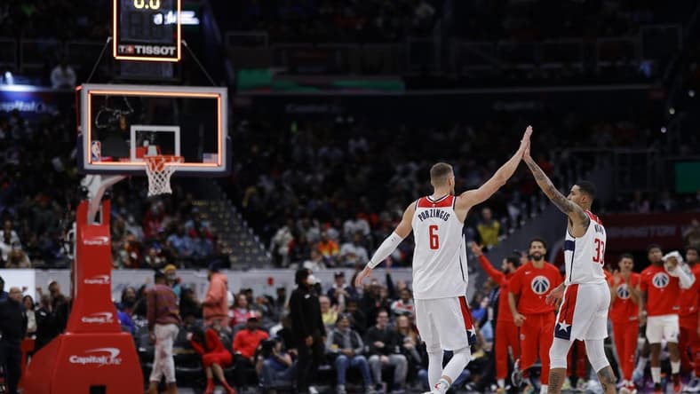 Nov 13, 2022; Washington, District of Columbia, USA; Washington Wizards center Kristaps Porzingis (6) celebrates with Wizards forward Kyle Kuzma (33) after making a three point field goal against the Memphis Grizzlies before the horn to end the second quarter at Capital One Arena. Mandatory Credit: Geoff Burke-USA TODAY Sports