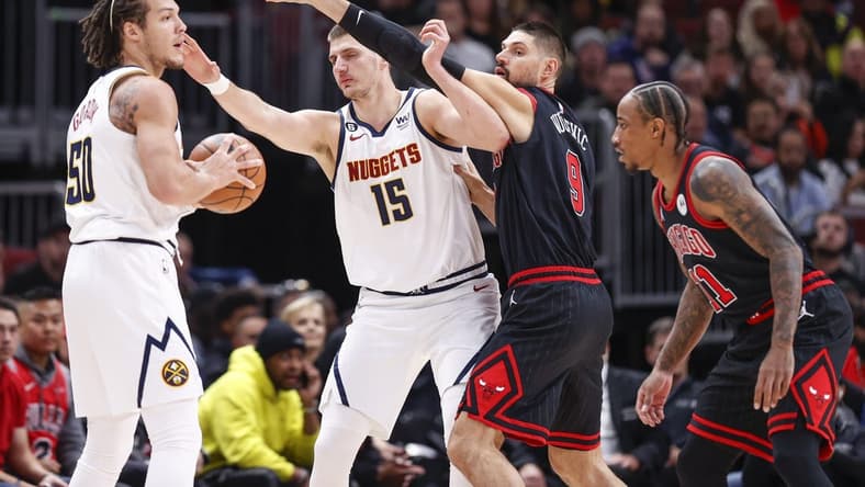 Nov 13, 2022; Chicago, Illinois, USA; Chicago Bulls center Nikola Vucevic (9) defends against Denver Nuggets center Nikola Jokic (15) during the first half at United Center. Mandatory Credit: Kamil Krzaczynski-USA TODAY Sports