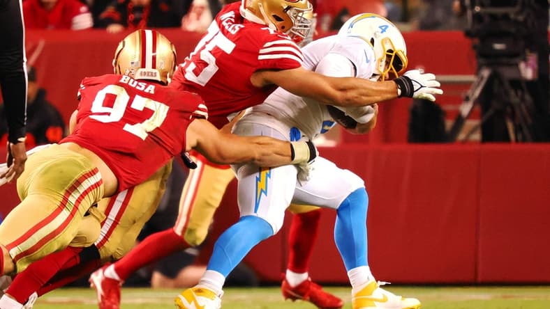 Nov 13, 2022; Santa Clara, California, USA; San Francisco 49ers defensive end Nick Bosa (97) and defensive end Jordan Willis (75) sack Los Angeles Chargers quarterback Chase Daniel (4) during the second quarter at Levi's Stadium. Mandatory Credit: Kelley L Cox-USA TODAY Sports