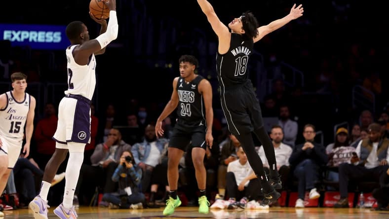 Nov 13, 2022; Los Angeles, California, USA; Brooklyn Nets forward Yuta Watanabe (18) defends against Los Angeles Lakers guard Kendrick Nunn (12) during the first quarter at Crypto.com Arena. Mandatory Credit: Kiyoshi Mio-USA TODAY Sports
