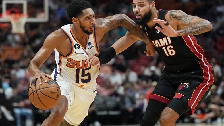 Nov 14, 2022; Miami, Florida, USA;Phoenix Suns guard Cameron Payne (15) drives past Miami Heat forward Caleb Martin (16) in the first half at FTX Arena. Mandatory Credit: Jim Rassol-USA TODAY Sports