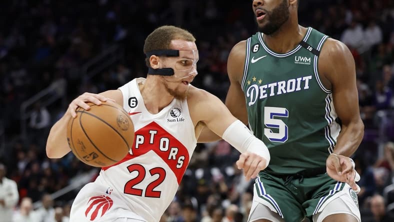 Nov 14, 2022; Detroit, Michigan, USA; Toronto Raptors guard Malachi Flynn (22) dribbles defended by Detroit Pistons guard Alec Burks (5) in the first half at Little Caesars Arena. Mandatory Credit: Rick Osentoski-USA TODAY Sports