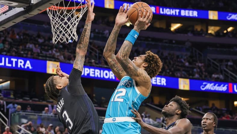 Nov 14, 2022; Orlando, Florida, USA; Charlotte Hornets guard Kelly Oubre Jr. (12) goes to the basket against Orlando Magic forward Chuma Okeke (3) during the second quarter at Amway Center. Mandatory Credit: Mike Watters-USA TODAY Sports