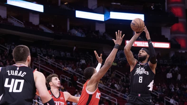 Nov 14, 2022; Houston, Texas, USA;  LA Clippers forward Marcus Morris Sr. (8) shoots against Houston Rockets forward Jabari Smith Jr. (1) in the first quarter at Toyota Center. Mandatory Credit: Thomas Shea-USA TODAY Sports