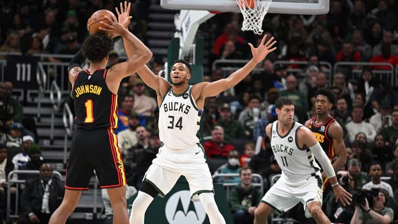 Nov 14, 2022; Milwaukee, Wisconsin, USA; Milwaukee Bucks forward Giannis Antetokounmpo (34) defends against Atlanta Hawks forward Jalen Johnson (1) in the second quarter at Fiserv Forum. Mandatory Credit: Michael McLoone-USA TODAY Sports