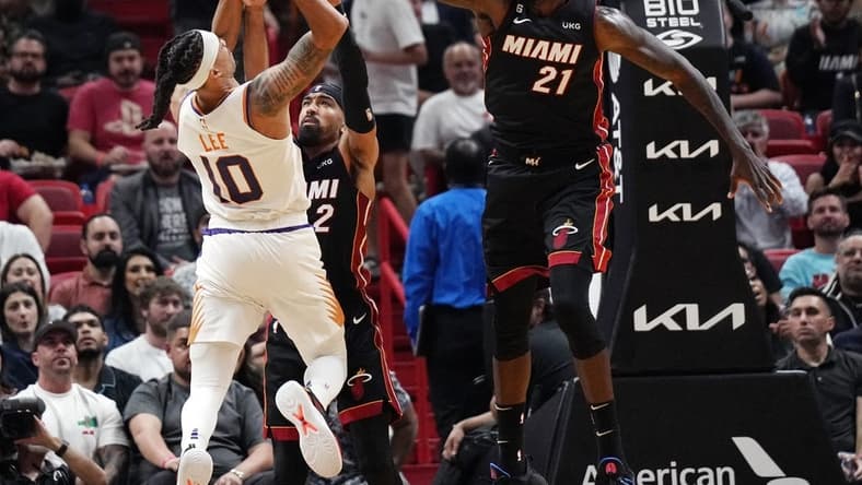 Nov 14, 2022; Miami, Florida, USA; Miami Heat center Dewayne Dedmon (21) defends a shot of Phoenix Suns guard Damion Lee (10) in the second half at FTX Arena. Mandatory Credit: Jim Rassol-USA TODAY Sports