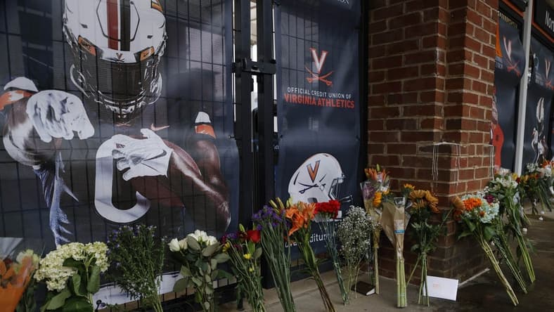 Nov 15, 2022; Charlottesville, Virginia, US; A view of flowers placed at a makeshift memorial outside Scott Stadium in memory of three Virginia Cavaliers football players who were killed in a shooting on the grounds of the University of Virginia in Charlottesville. Mandatory Credit: Geoff Burke-USA TODAY NETWORK