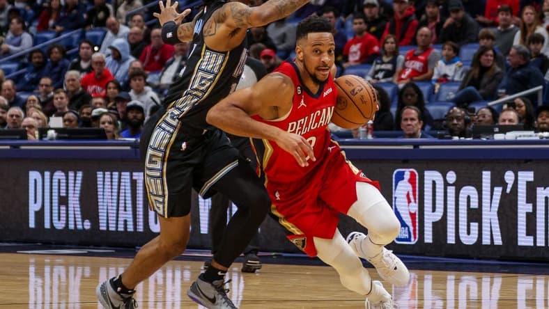 Nov 15, 2022; New Orleans, Louisiana, USA; New Orleans Pelicans guard CJ McCollum (3) drives to the basket against Memphis Grizzlies guard Ja Morant (12) during the first half at Smoothie King Center. Mandatory Credit: Stephen Lew-USA TODAY Sports