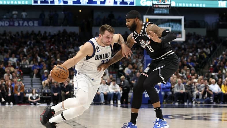 Nov 15, 2022; Dallas, Texas, USA; Dallas Mavericks guard Luka Doncic (77) dribbles as LA Clippers forward Marcus Morris Sr. (8) defends during the first quarter at American Airlines Center. Mandatory Credit: Kevin Jairaj-USA TODAY Sports
