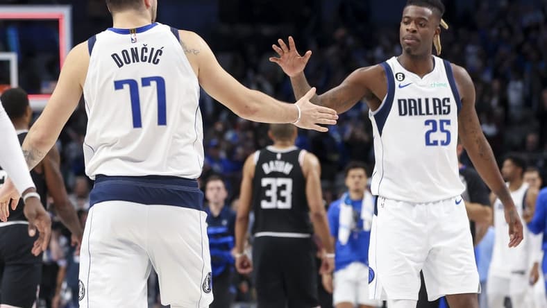 Nov 15, 2022; Dallas, Texas, USA; Dallas Mavericks guard Luka Doncic (77) celebrates with Dallas Mavericks forward Reggie Bullock (25) after the game against the LA Clippers at American Airlines Center. Mandatory Credit: Kevin Jairaj-USA TODAY Sports