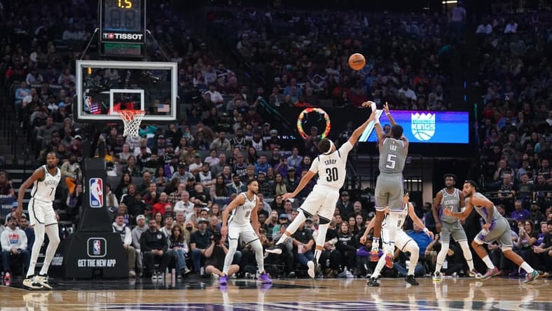 Nov 15, 2022; Sacramento, California, USA; Sacramento Kings guard De'Aaron Fox (5) makes a shot over Brooklyn Nets guard Seth Curry (30) at the end of the first quarter at the Golden 1 Center. Mandatory Credit: Cary Edmondson-USA TODAY Sports