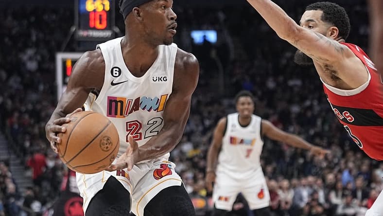 Nov 16, 2022; Toronto, Ontario, CAN; Miami Heat forward Jimmy Butler (22) looks for a play as Toronto Raptors guard Fred VanVleet (23) defends during the first quarter at Scotiabank Arena. Mandatory Credit: John E. Sokolowski-USA TODAY Sports