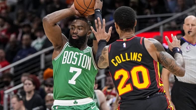 Nov 16, 2022; Atlanta, Georgia, USA; Boston Celtics guard Jaylen Brown (7) is defended by Atlanta Hawks forward John Collins (20) during the first half at State Farm Arena. Mandatory Credit: Dale Zanine-USA TODAY Sports
